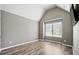 Bright bedroom showcasing vaulted ceilings, hardwood floors and a large window at 7698 Hansel Ln, Lithonia, GA 30058