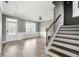 Inviting foyer showcasing hardwood floors, staircase, and contemporary lighting at 7698 Hansel Ln, Lithonia, GA 30058