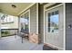 Covered front porch featuring stone accents, a bench, and stylish door at 7698 Hansel Ln, Lithonia, GA 30058