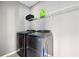 Practical laundry room includes side-by-side washer and dryer, plus storage shelf at 7698 Hansel Ln, Lithonia, GA 30058