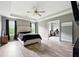 Spacious primary bedroom with recessed lighting features adjacent ensuite bathroom at 7698 Hansel Ln, Lithonia, GA 30058