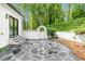 Backyard featuring an arched gate, landscaped features, and stone walkway at 900 Edgewater Nw Dr, Atlanta, GA 30328