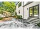 Backyard view featuring stone walkway, lush landscaping, and the home's exterior at 900 Edgewater Nw Dr, Atlanta, GA 30328