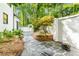 Landscaped backyard with stone walkway, custom wall and gated entrance at 900 Edgewater Nw Dr, Atlanta, GA 30328