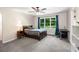 Bedroom includes a large window, desk and shelves, and neutral carpet at 900 Edgewater Nw Dr, Atlanta, GA 30328