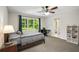 Bedroom includes a large window, desk and shelves, and neutral carpet at 900 Edgewater Nw Dr, Atlanta, GA 30328