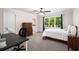 Bright bedroom with a large window, desk, dresser, and neutral carpet at 900 Edgewater Nw Dr, Atlanta, GA 30328