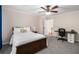 Bedroom features neutral walls, carpet, and a ceiling fan above bed and desk at 900 Edgewater Nw Dr, Atlanta, GA 30328
