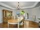 Bright dining room with hardwood floors, a display cabinet, and an arched window view to the backyard at 900 Edgewater Nw Dr, Atlanta, GA 30328