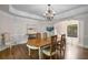 Classic dining room with hardwood floors, a view to the entry and backyard, and traditional furnishings at 900 Edgewater Nw Dr, Atlanta, GA 30328
