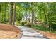 Long driveway leading to the house, surrounded by lush greenery and mature trees at 900 Edgewater Nw Dr, Atlanta, GA 30328
