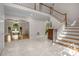 Elegant foyer featuring a grand staircase, marble floors and entry to formal dining area at 900 Edgewater Nw Dr, Atlanta, GA 30328