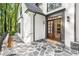 Inviting front entrance boasting stone walkway, meticulous landscaping and beautiful wood double doors at 900 Edgewater Nw Dr, Atlanta, GA 30328