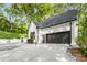 Spacious driveway leading to a modern home with a large garage and convenient gated access at 900 Edgewater Nw Dr, Atlanta, GA 30328