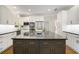 Modern kitchen with stainless steel appliances, granite counters, white cabinets, and large center island at 900 Edgewater Nw Dr, Atlanta, GA 30328