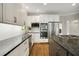 Bright kitchen featuring white cabinets, granite countertops, stainless appliances, and hardwood floors at 900 Edgewater Nw Dr, Atlanta, GA 30328