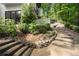 Stone steps in the back yard leading up to the house, surrounded by lush greenery at 900 Edgewater Nw Dr, Atlanta, GA 30328