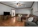 Comfortable living room features hardwood floors, wood trim, ceiling fan and a large sectional couch at 900 Edgewater Nw Dr, Atlanta, GA 30328