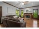 Inviting living room with hardwood floors, a fireplace, and large windows providing ample natural light at 900 Edgewater Nw Dr, Atlanta, GA 30328