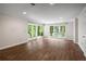 Sun-filled living room featuring wood floors and views of lush landscaping at 900 Edgewater Nw Dr, Atlanta, GA 30328