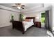 Main bedroom boasts tray ceilings, a ceiling fan and a beautiful view of the trees outside at 900 Edgewater Nw Dr, Atlanta, GA 30328