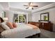 Main bedroom boasts tray ceilings, a ceiling fan and a beautiful view of the trees outside at 900 Edgewater Nw Dr, Atlanta, GA 30328