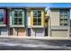 Modern townhome with colorful exterior, large windows, and individual garages at 1360 Peter Haughton Nw Way, Atlanta, GA 30318