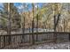 Backyard with a wooden fence and various trees in the distance at 1538 Park Grove Dr, Lawrenceville, GA 30046