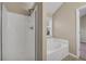 Modern bathroom showcasing a glass-door shower, soaking tub, and natural light, creating a relaxing space at 1538 Park Grove Dr, Lawrenceville, GA 30046