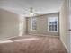 Bright bedroom with large windows, a ceiling fan, and neutral carpeting for a cozy and inviting atmosphere at 1538 Park Grove Dr, Lawrenceville, GA 30046