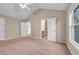 Bright bedroom featuring neutral walls, a ceiling fan, and doorway views of the adjacent rooms at 1538 Park Grove Dr, Lawrenceville, GA 30046