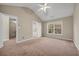 Large bedroom with neutral walls, a ceiling fan, and an attached bathroom with a soaking tub at 1538 Park Grove Dr, Lawrenceville, GA 30046