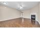 Spacious living room with hardwood floors, a fireplace, and a ceiling fan at 1538 Park Grove Dr, Lawrenceville, GA 30046
