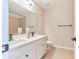 Well-lit bathroom featuring double sink vanity, a large mirror, tile flooring, and a tiled shower at 20 Daniel Crk, Sugar Hill, GA 30518