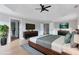 Staged bedroom with king bed, flat screen televisions, and modern furniture at 20 Daniel Crk, Sugar Hill, GA 30518