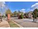 Community entrance gate with brick pillars and a covered guard house at 20 Daniel Crk, Sugar Hill, GA 30518
