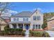 Charming two-story home featuring a brick facade, blue shutters, a welcoming porch, and well-maintained landscaping at 20 Daniel Crk, Sugar Hill, GA 30518
