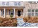 Inviting front porch featuring white columns, brick accents, and a partially open front door at 20 Daniel Crk, Sugar Hill, GA 30518