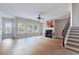 Bright living room featuring hardwood floors, a fireplace, and a staircase at 20 Daniel Crk, Sugar Hill, GA 30518