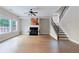 Spacious living room with a fireplace, large windows, and a staircase to the second floor at 20 Daniel Crk, Sugar Hill, GA 30518