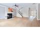 Bright living room with a fireplace, staircase, and view of the front door at 20 Daniel Crk, Sugar Hill, GA 30518