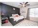 Chic bedroom featuring a dark accent wall and modern ceiling fan at 2718 Serena Way, Atlanta, GA 30331
