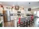Spacious kitchen with stainless steel appliances, island with seating, and modern light fixtures at 2718 Serena Way, Atlanta, GA 30331