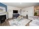 Inviting living room with fireplace, large TV, and comfortable gray sectional sofa at 2718 Serena Way, Atlanta, GA 30331
