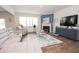 Open living area with a fireplace, large window, and plush gray seating at 2718 Serena Way, Atlanta, GA 30331