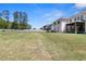 Spacious backyard with green grass and a white fence, offering privacy and plenty of room for outdoor activities at 2989 Waterford Dr, Conyers, GA 30094