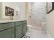 Bathroom with marble counters, custom cabinets, and tiled walk-in shower at 2989 Waterford Dr, Conyers, GA 30094