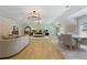 Open bedroom with chandeliers, hardwood floors, sitting area and mint colored wall at 2989 Waterford Dr, Conyers, GA 30094