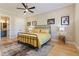 Bedroom with a brass bed frame, stylish lighting, paneling, and natural light at 2989 Waterford Dr, Conyers, GA 30094