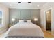 Comfortable bedroom features modern wainscotting, ensuite bathroom, and hardwood floors at 2989 Waterford Dr, Conyers, GA 30094